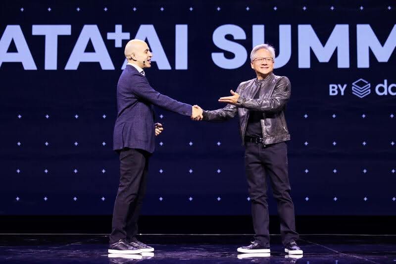 Ali Ghodsi shakes hands with Jensen Huang at the Databricks Data + AI Summit 2024.