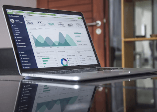 Opened laptop on a desk showcasing analytical data in a dashboard.